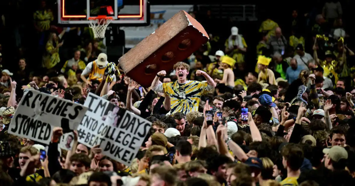 Wake Forest fans collide with Duke star Kyle Filipowski while storming court
